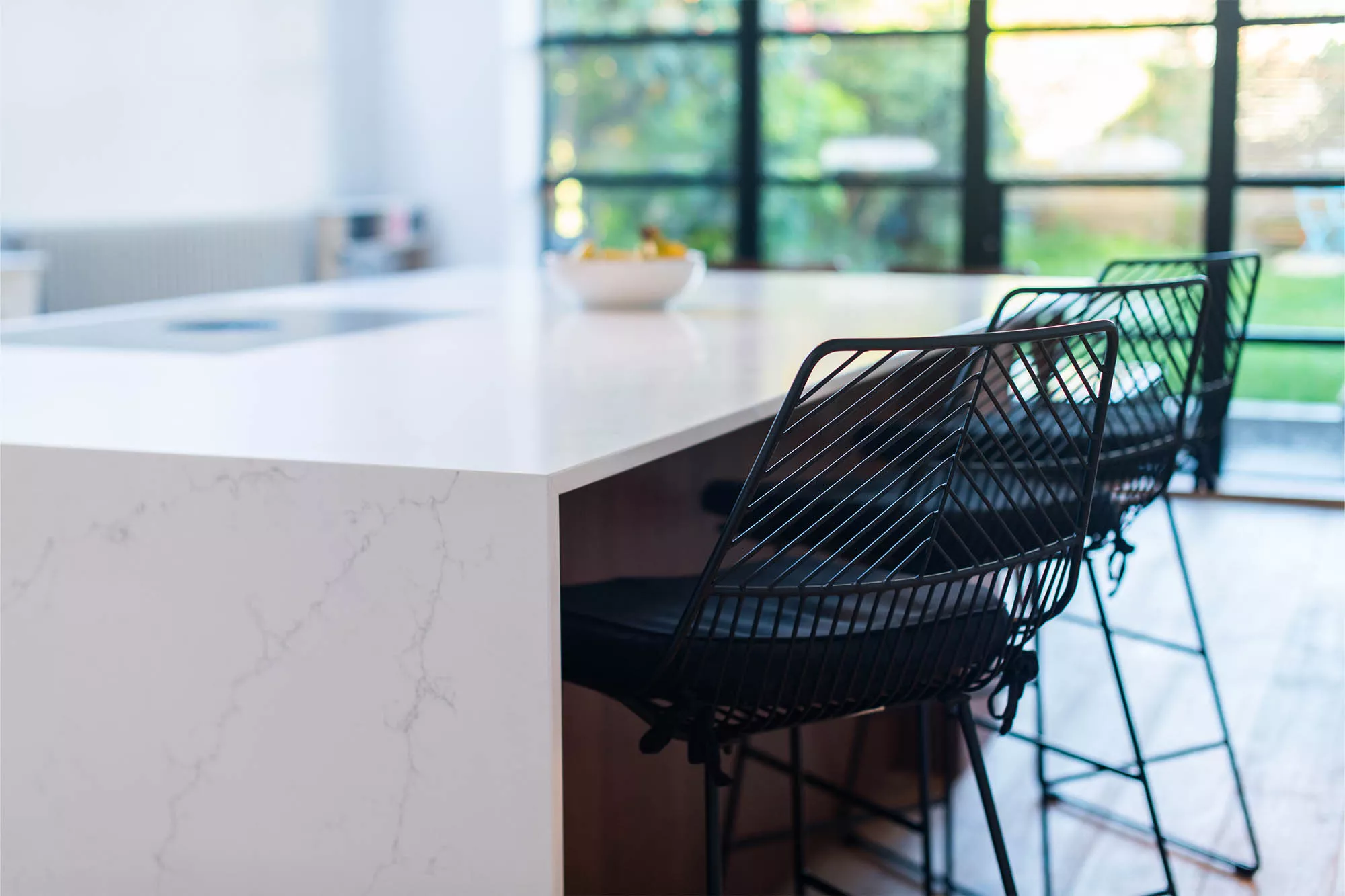 contemporary white kitchen island with bar chairs