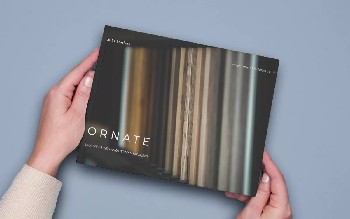 birds eye view of someone holding a physical kitchen brochure