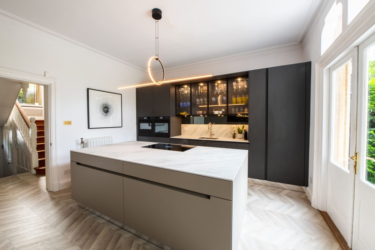 Luxury modern kitchen with large island, handleless cabinetry and integrated lighting by Ornate Kitchens