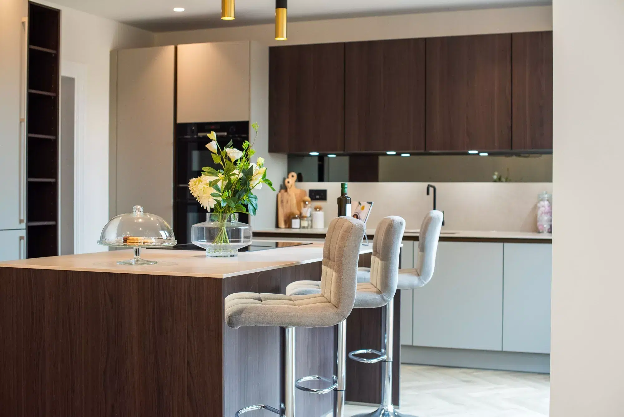 Contemporary kitchen renovation with walnut island breakfast bar and handleless cabinetry by Ornate Kitchens