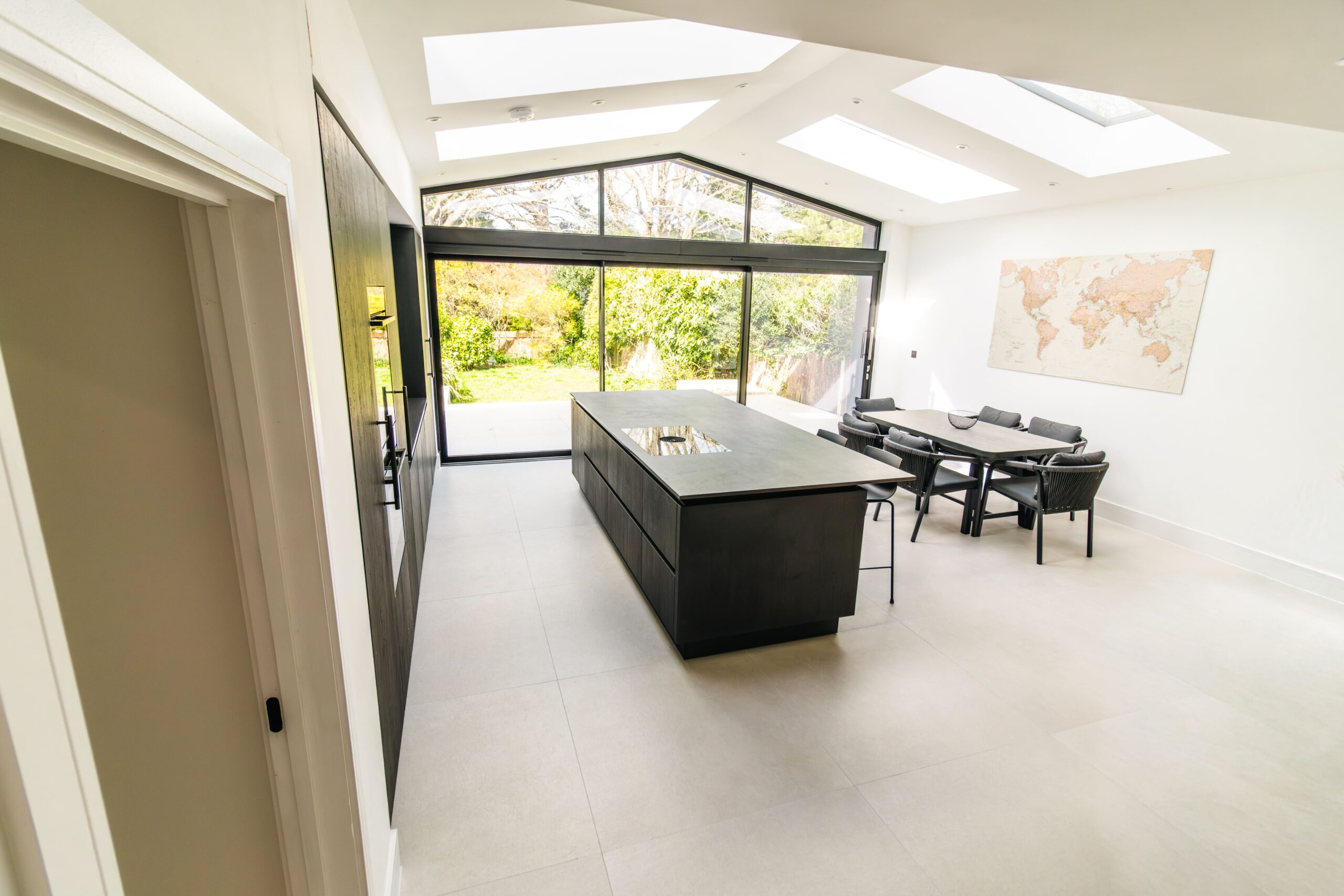 Modern kitchen extension with skylights and natural light enhancing ambient kitchen lighting design